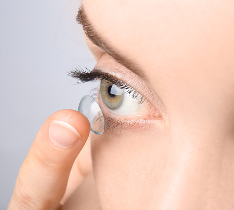 Woman putting a contact lens into her eye